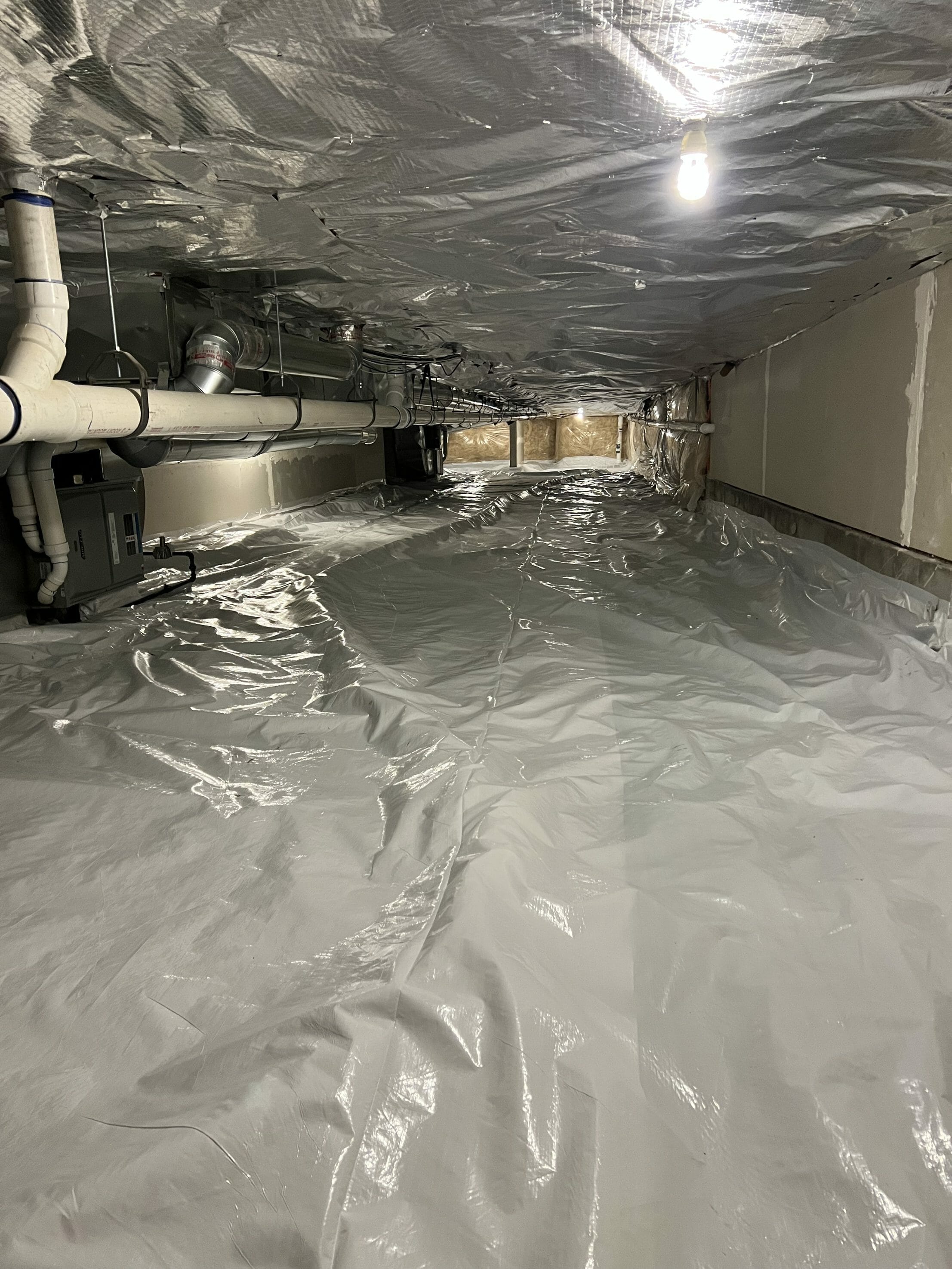 Utah Radon Defense technician installing crawl space encapsulation as part of a comprehensive radon mitigation system