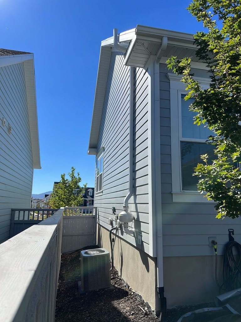Side view of house with radon mitigation system repair in Utah
